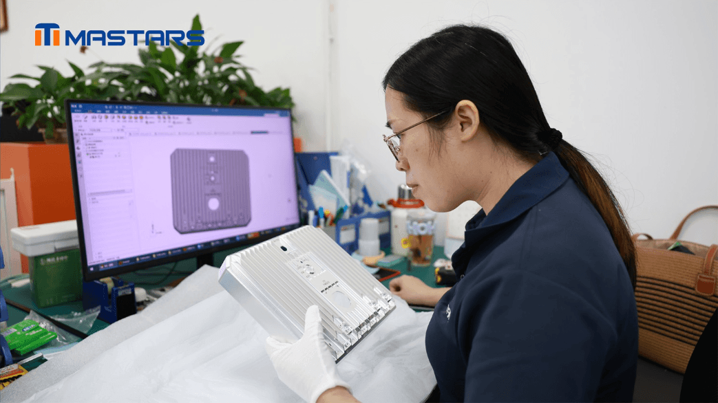 Mastars engineer inspecting machined features and surface quality against the digital model.