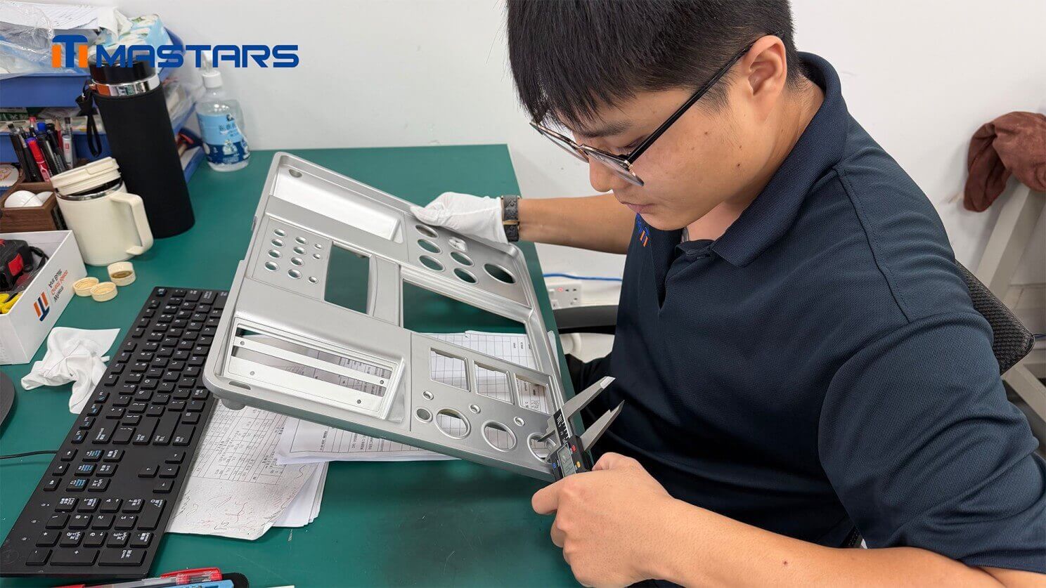 Mastars engineer inspecting the pearl chrome finished plastic prototype and its dimensional features.