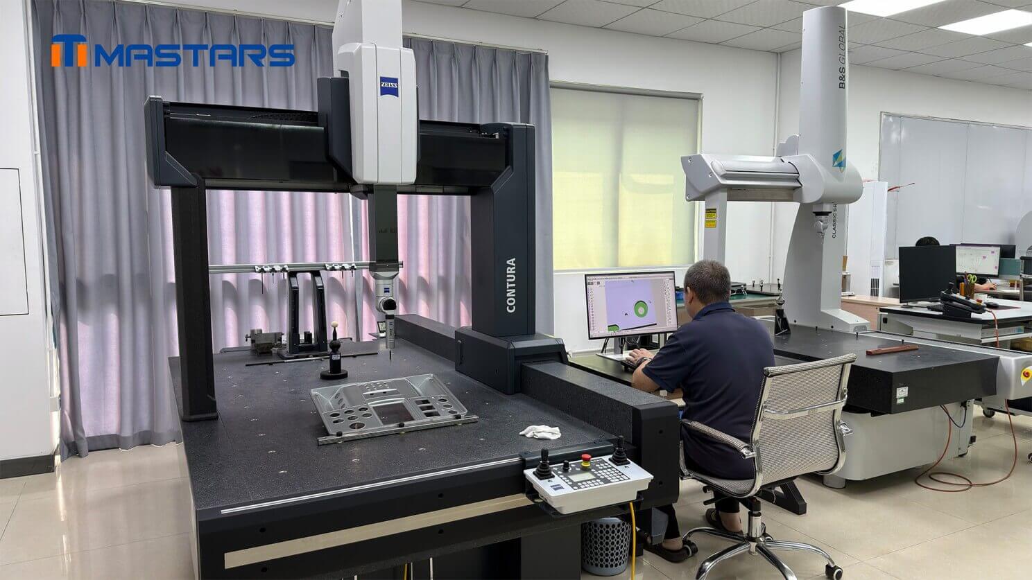 Coordinate measuring machine inspecting a complex control panel for dimensional accuracy and consistency. 