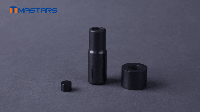 Black ceramic components featuring cylindrical profiles, precision bores, and smooth finished surfaces Black ceramic components featuring cylindrical profiles, precision bores, and smooth finished surfaces